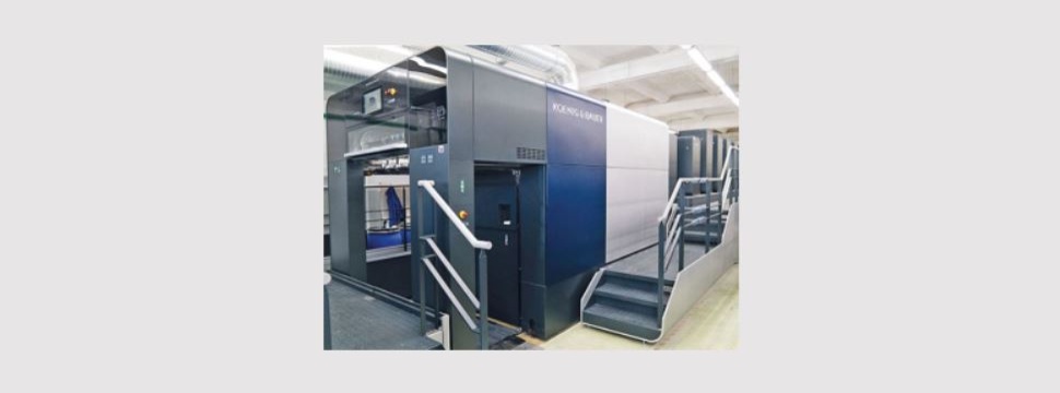 The press comprises six printing units, coater and extended delivery, and stands on a 555 mm plinth