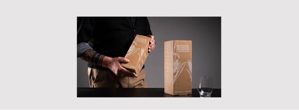 White digital printing on brown paper supports premium presentation for Riedel Glas