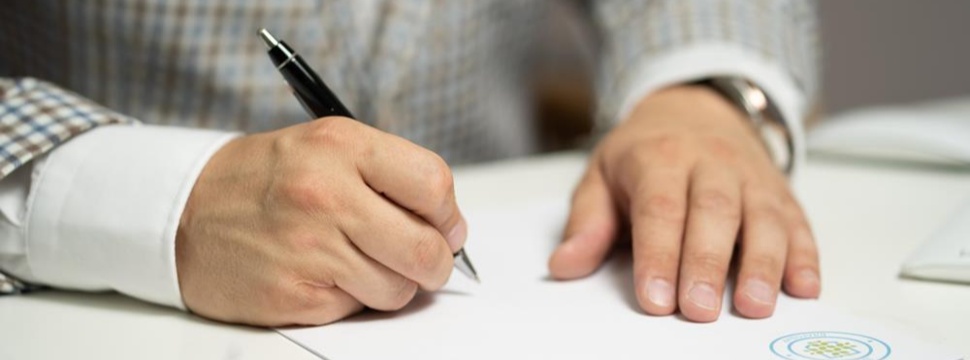 Man signs a document