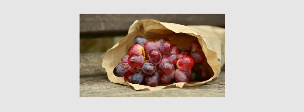 Grapes in a bag made of light kraft paper