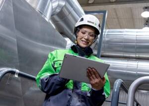 Valmet employee in front of pipelines