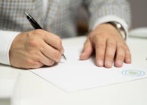 Man signs a document