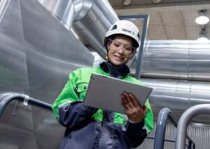 Valmet employee in front of pipelines