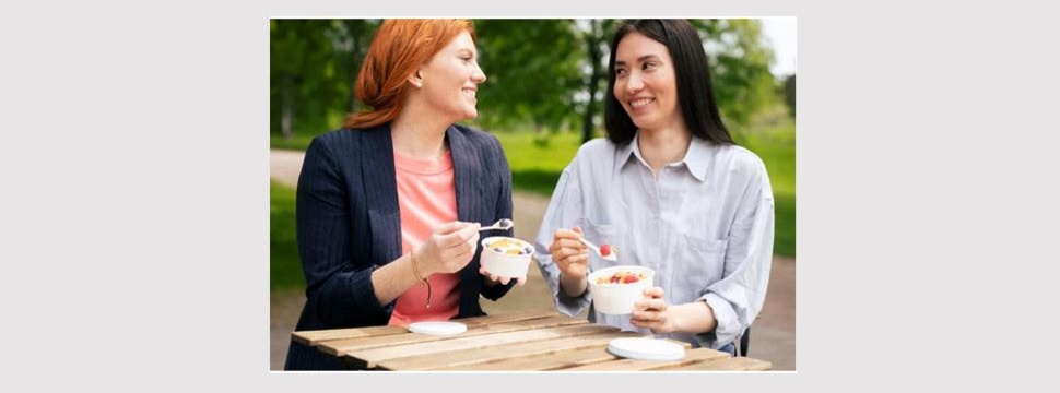 Two women eating yoghurt